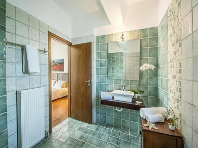 a bathroom with a sink and a mirror at Private Pool & Garden Villa for 6 in Pemónia