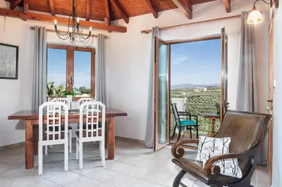 a dining room with a table and chairs at Andromia Studios & Apartments in Agia Marina Nea Kydonias