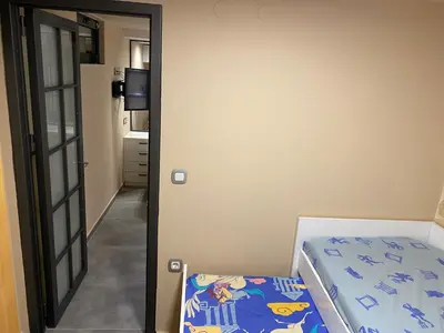 a bedroom with a bed and a mirror at Papaduke House in Kalyves