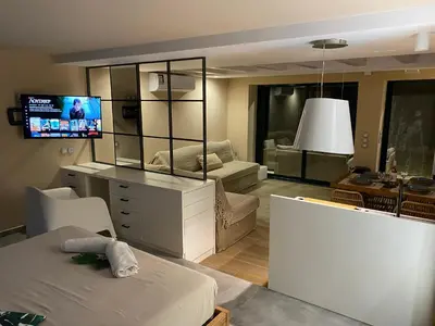 a living room with a large mirror and a couch at Papaduke House in Kalyves