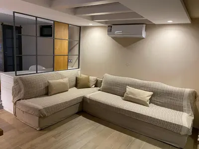 a living room with a couch in a room at Papaduke House in Kalyves