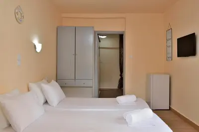 a bedroom with two beds with white pillows at Urban Studios Manos in Chania Town