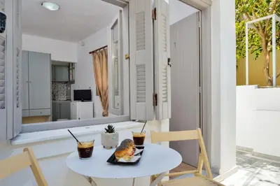 a table with a plate of food on it in a room at Urban Studios Manos in Chania Town