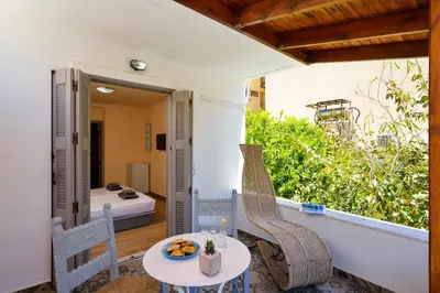 a patio with a table and a chair on a balcony at Urban Studios Manos in Chania Town