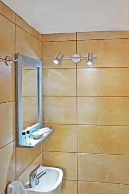 a bathroom with a sink and a mirror at Urban Studios Manos in Chania Town