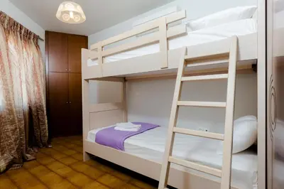 a bunk bed with a ladder in a room at Sea Side House Rapanas in Falasarna