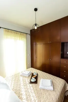 a bedroom with a bed with a tray of food on it at Sea Side House Rapanas in Falasarna
