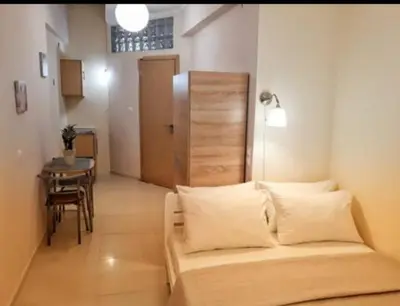 a room with a bed and a table and a chair at Konstantina's studio near the beach in Chania Town