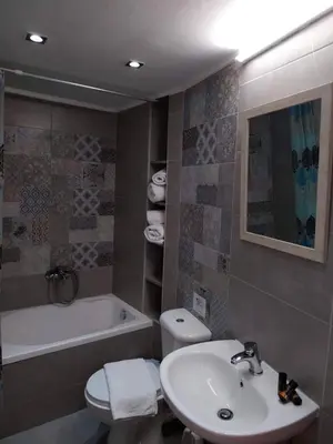 a bathroom with a sink and a toilet and a tub at Konstantina's studio near the beach in Chania Town