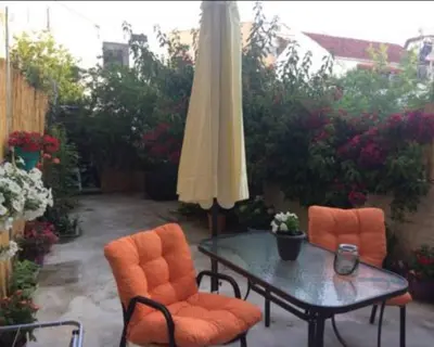 a patio with a table and chairs and an umbrella at Konstantina's studio near the beach in Chania Town