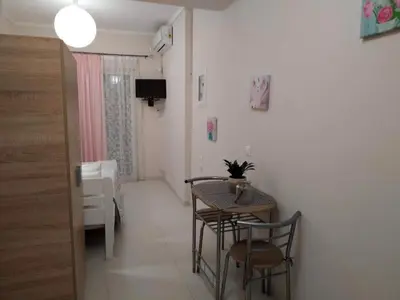 a small dining room with a table and chairs at Konstantina's studio near the beach in Chania Town
