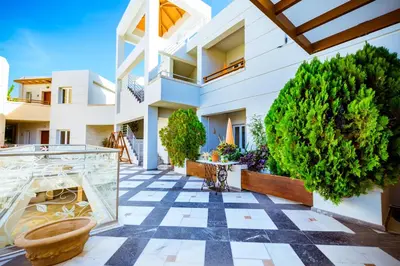 a house with a fish tank in a courtyard at Anais Collection Hotels & Suites in Kato Daratso