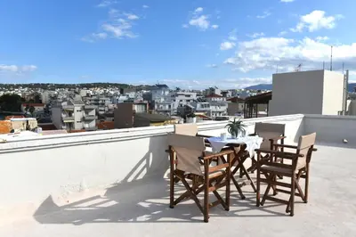 a table and chairs on the roof of a building at Apartment in Koomkapi in Chania Town