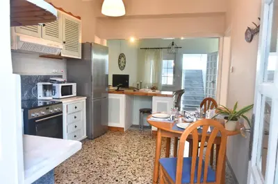 a kitchen with a small table and a kitchen with a counter at Apartment in Koomkapi in Chania Town