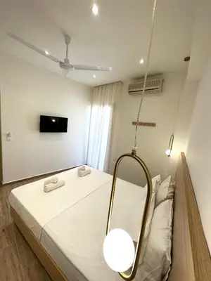 a hospital room with a bed and a mirror at Lissos Rooms Sougia in Sougia