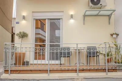 a balcony with a metal railing in front of a building at The 3 Brothers' Apts in Chania Town