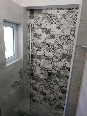 a bathroom with a shower with a glass door at The 3 Brothers' Apts in Chania Town