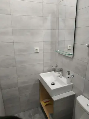 a bathroom with a sink and a mirror at The 3 Brothers' Apts in Chania Town