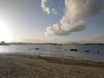 a beach with people in the water at The 3 Brothers' Apts in Chania Town