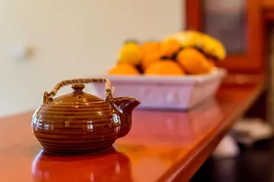 a tea pot sitting on a table with a bowl of oranges at Villa Helen 200m from the beach in Tersanas BY APOKORONAS-VILLAS in Tersanas