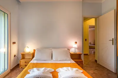 a bedroom with a bed with two pillows on it at Villa Helen 200m from the beach in Tersanas BY APOKORONAS-VILLAS in Tersanas