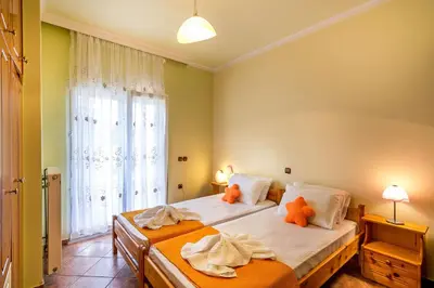 a bedroom with two beds with orange stuffed animals on them at Villa Helen 200m from the beach in Tersanas BY APOKORONAS-VILLAS in Tersanas