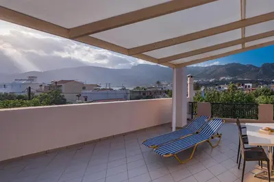a patio with two chairs and a table on a balcony at Niki's Apartment in Palaiochóra