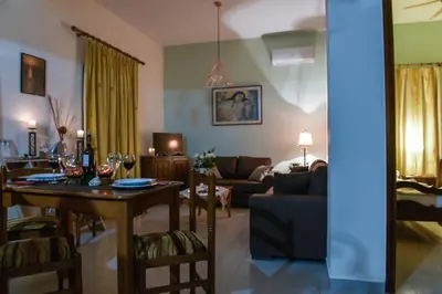 a living room with a table and a living room with a couch at Aromatic Home in Kissamos