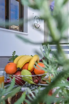 a bowl of fruit sitting on a table at Aromatic Home in Kissamos