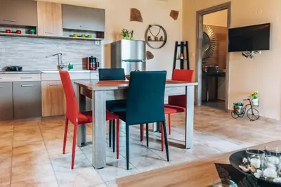a kitchen with a table and four chairs at Villa Stafidaki in Stalos