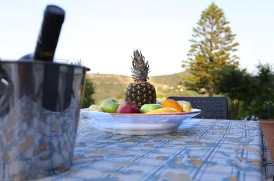 a bowl of fruit on a table with a pineapple at Archontiko Haris in Kolymvari