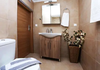 a bathroom with a sink and a toilet and a mirror at Archontiko Haris in Kolymvari