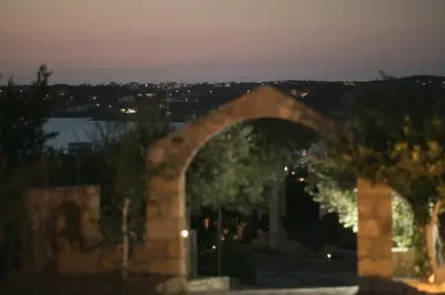 an arch in a building with a view of the water at Creta Vitalis in Kalathas