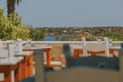 a view of a table and chairs on a balcony at Creta Vitalis in Kalathas