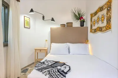 a bedroom with a white bed with white pillows at Creta Vitalis in Kalathas