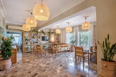 a dining room with a table and chairs and chandeliers at Creta Vitalis in Kalathas