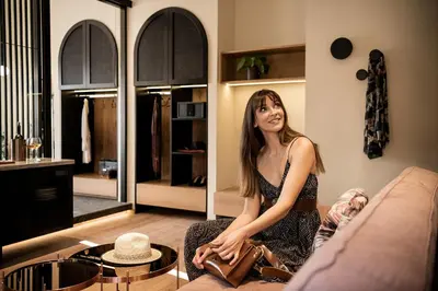 a woman sitting on a couch in a living room at Divino Suites Chania in Chania Town