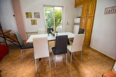 a kitchen with a table and chairs in a room at Thanasis Villa in Kounoupidhianá