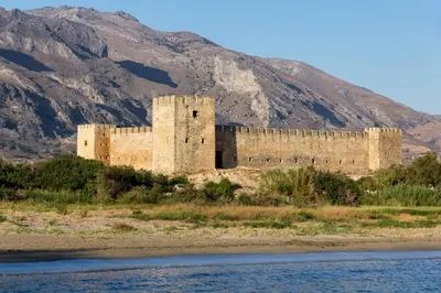 a castle on the side of a river with a mountain at Captain Tom in Frangokastello