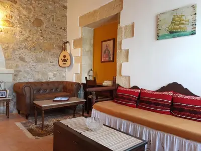 a living room with a bed and a couch at Wood & Stone in Kissamos