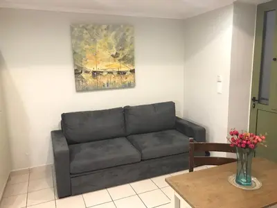 a living room with a couch and a table at Odyssey Apartment in Palaiochóra