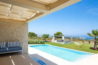 a villa with a swimming pool and a patio at Elias Luxury Villa in Kalathas