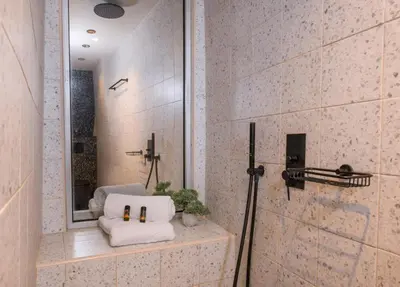 a bathroom with a shower with two towels at Cretan Berry Sarpaki in Chania Town