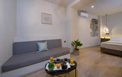 a living room with a couch and a table with drinks at Cretan Berry Sarpaki in Chania Town
