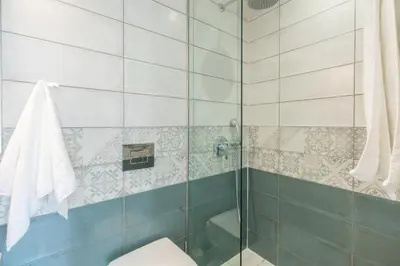 a bathroom with a shower and a toilet at Cretan Berry Portou in Chania Town