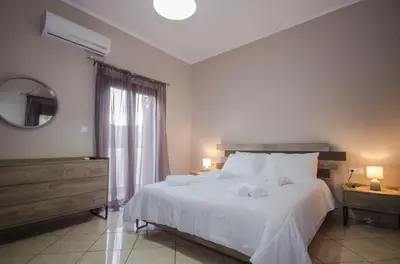 a bedroom with a large white bed and a window at Horio House in Límni