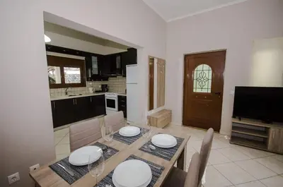a kitchen and dining room with a table and chairs at Horio House in Límni