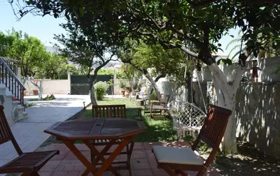 a wooden picnic table and chairs under a tree at Modern Apartment with Garden in Kissamos
