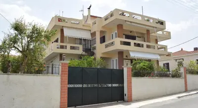 a house with a black gate in front of it at Modern Apartment with Garden in Kissamos