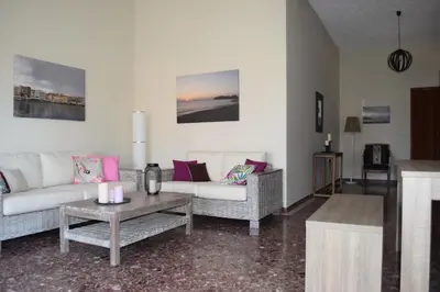 a living room with two couches and a coffee table at Modern Apartment with Garden in Kissamos